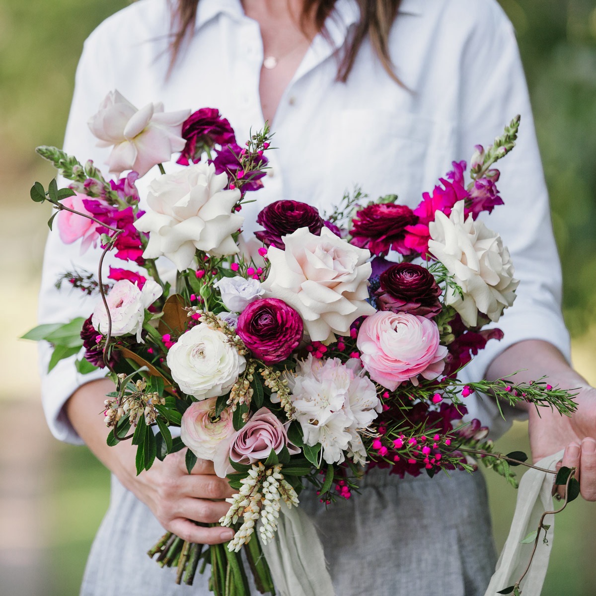 A romantic bridal bouquet in vintage pink and burgundy colours created by a local wedding florist of the Gold Coast