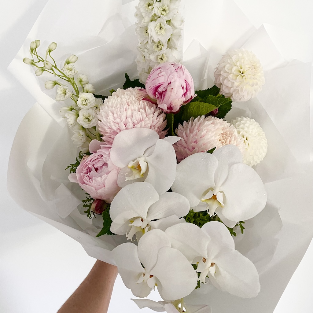 Bouquet of white phalaenopsis orchid, Dahlias, Delphinium and soft pink disbuds and peonies Hope island flower delivery Gold Coast
